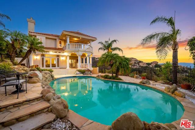 a view of a swimming pool with a patio