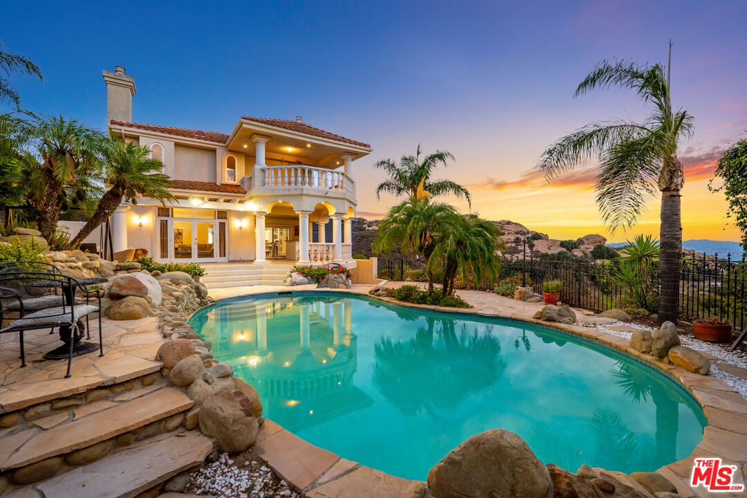 7449 Studio Road West Hills, CA 91304 - Photo 4 of 33 a view of a swimming pool with a patio