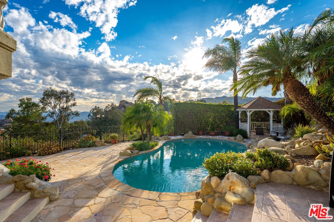 7449 Studio Road West Hills, CA 91304 - Photo 9 of 33 a view of a garden with an outdoor seating