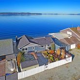 an aerial view of a house with a ocean view