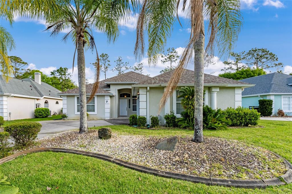 7 Meadow Ridge View Ormond Beach, FL 32174 - Photo 1 of 1 a front view of a house with garden