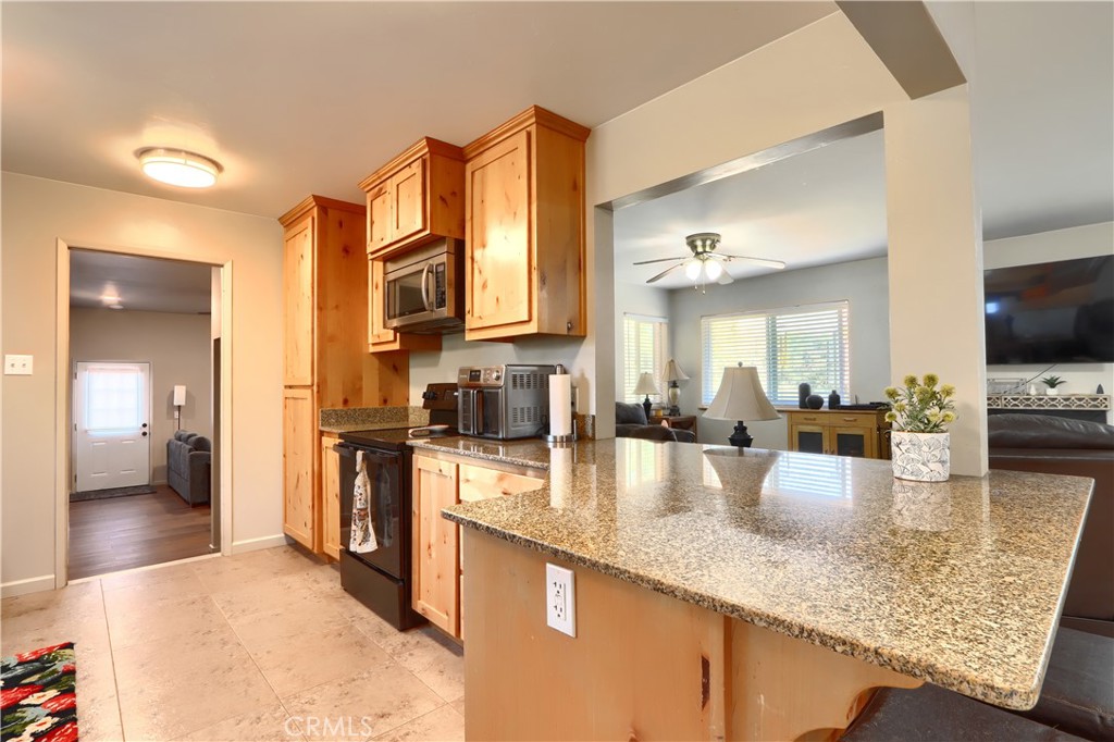 5268 Schafer Road Mariposa, CA 95338 - Photo 12 of 45 a large kitchen with granite countertop a large counter top appliances and cabinets