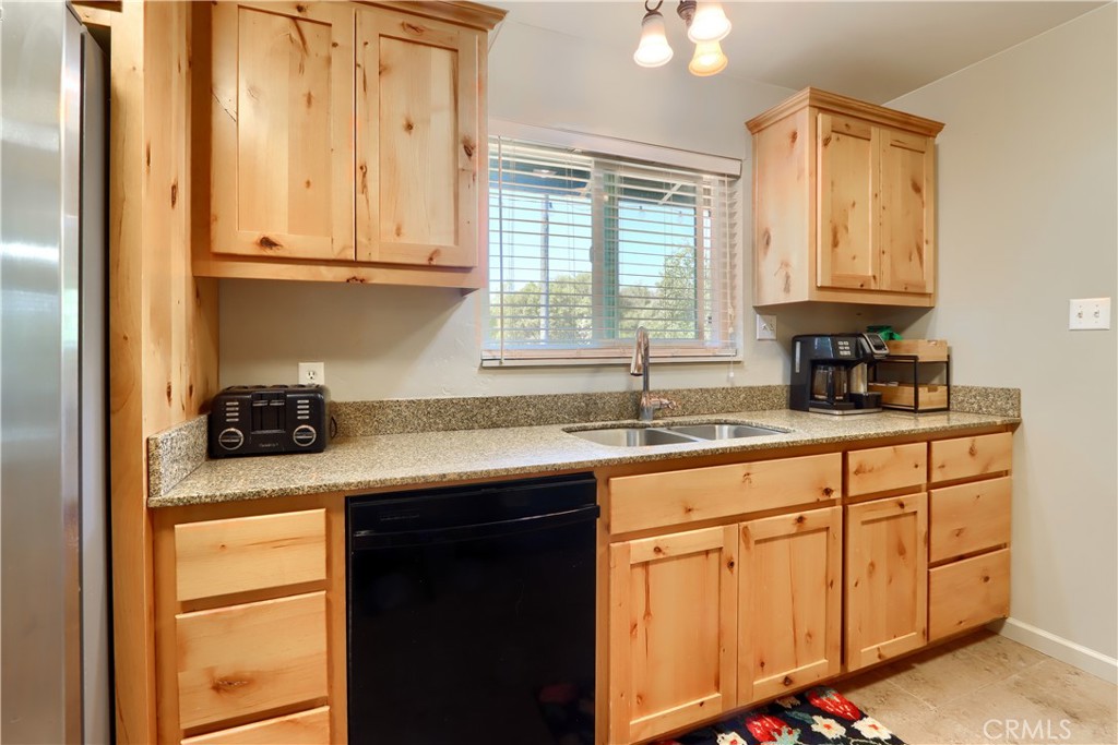 5268 Schafer Road Mariposa, CA 95338 - Photo 14 of 45 a kitchen with stainless steel appliances granite countertop a sink a stove and cabinets