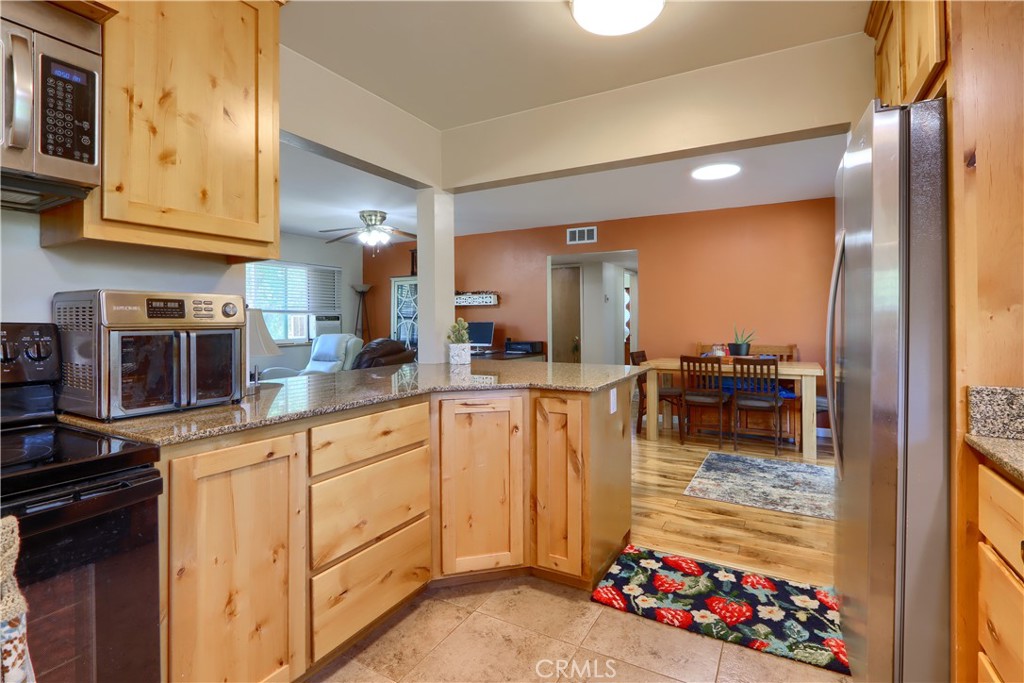 5268 Schafer Road Mariposa, CA 95338 - Photo 15 of 45 a kitchen with stove refrigerator and cabinets