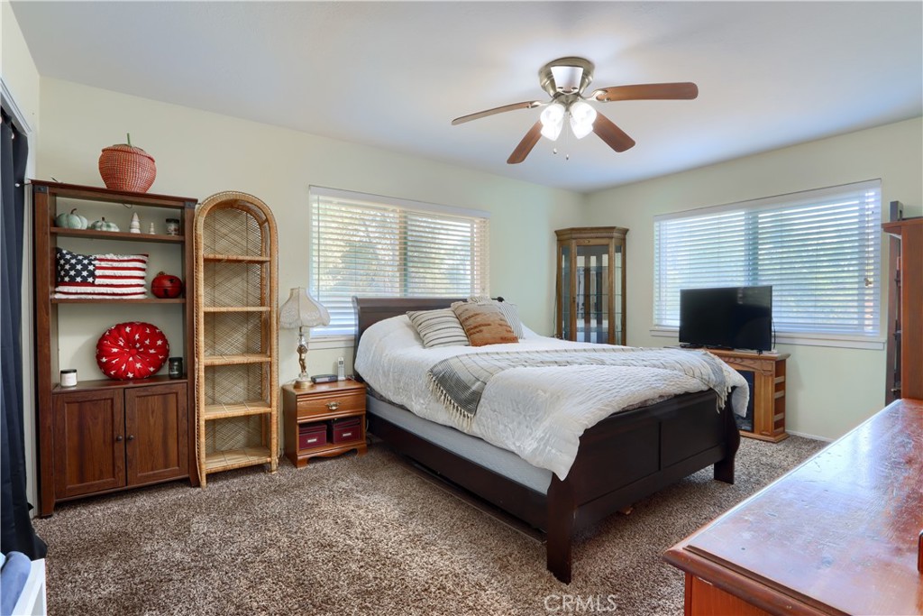 5268 Schafer Road Mariposa, CA 95338 - Photo 17 of 45 a bedroom with a bed and a chandelier