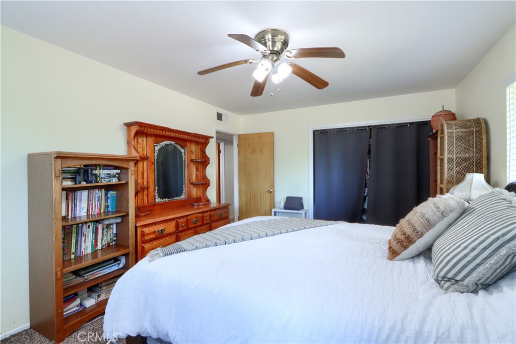 5268 Schafer Road Mariposa, CA 95338 - Photo 18 of 45 a bedroom with a large bed and a chandelier