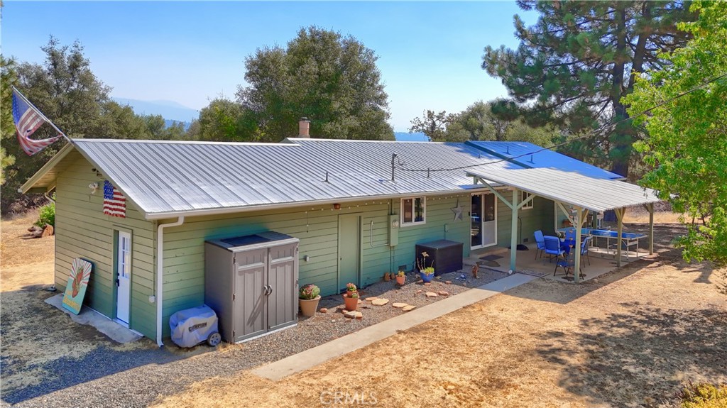 5268 Schafer Road Mariposa, CA 95338 - Photo 2 of 45 a view of a patio with table and chairs under an umbrella