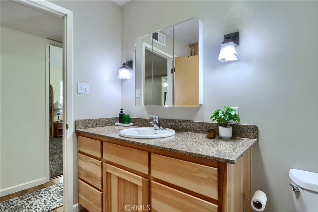 5268 Schafer Road Mariposa, CA 95338 - Photo 21 of 45 a bathroom with a granite countertop sink and a mirror