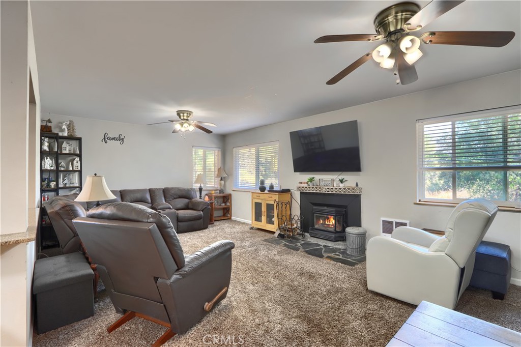 5268 Schafer Road Mariposa, CA 95338 - Photo 7 of 45 a living room with furniture a fireplace and a flat screen tv