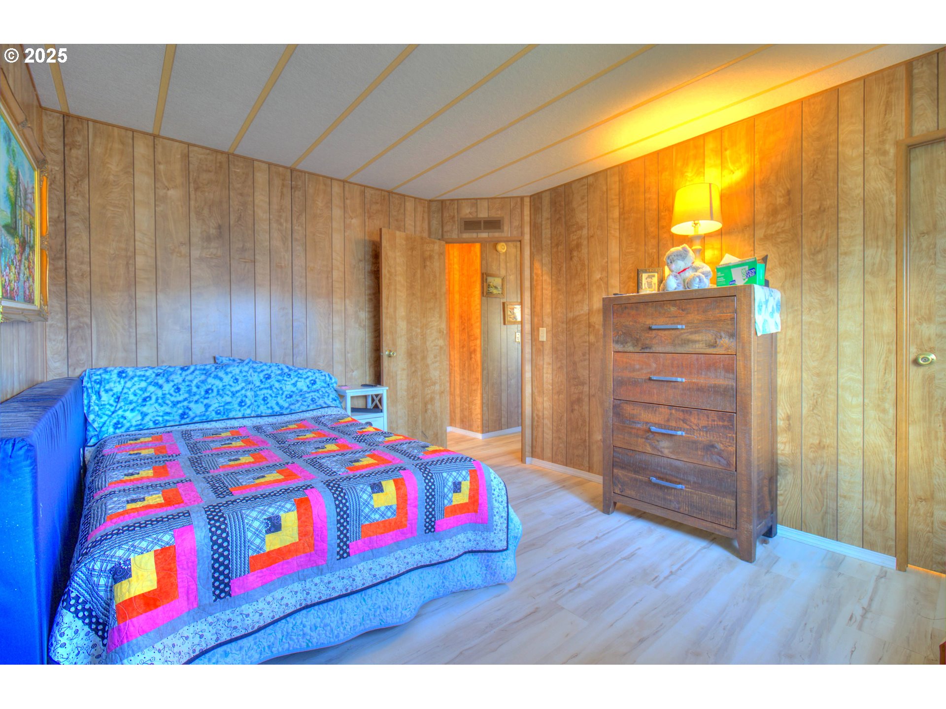 1109 Rowland Lane Brookings, OR 97415 - Photo 12 of 21 a bedroom with a bed and wooden floor