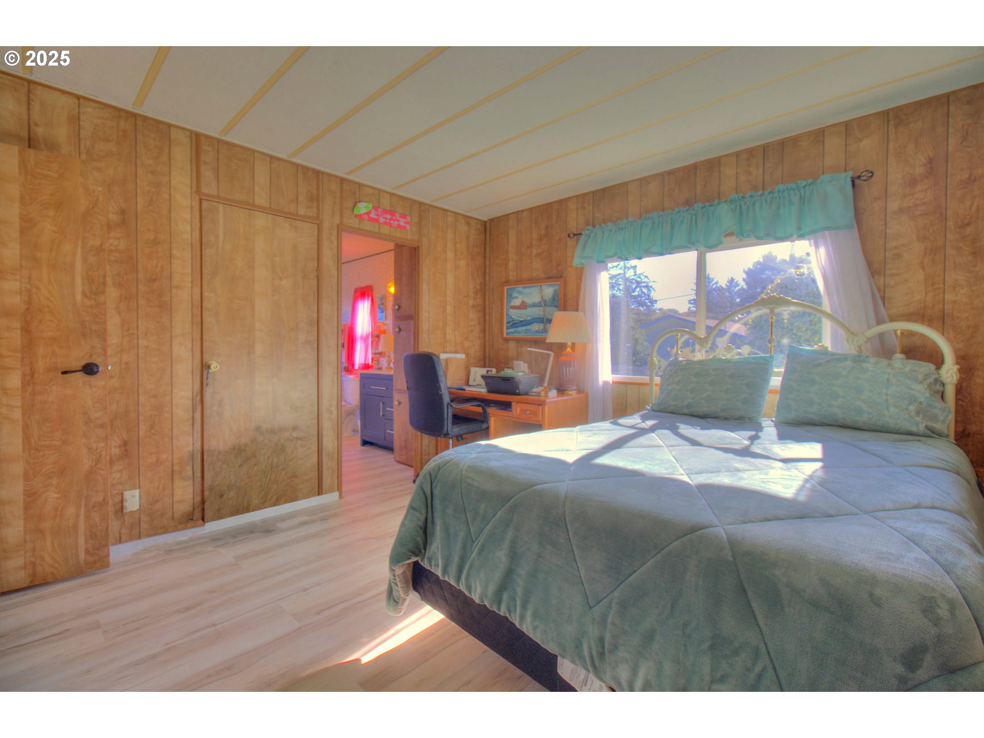 1109 Rowland Lane Brookings, OR 97415 - Photo 14 of 21 a bedroom with a bed and wooden floor