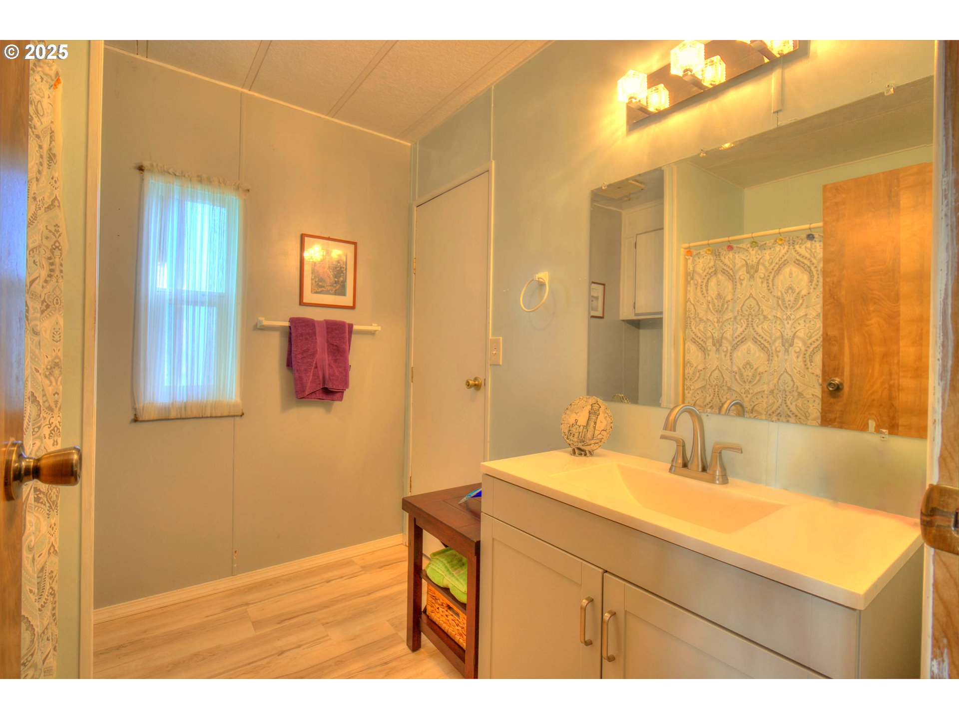 1109 Rowland Lane Brookings, OR 97415 - Photo 9 of 21 a bathroom with a sink and a mirror