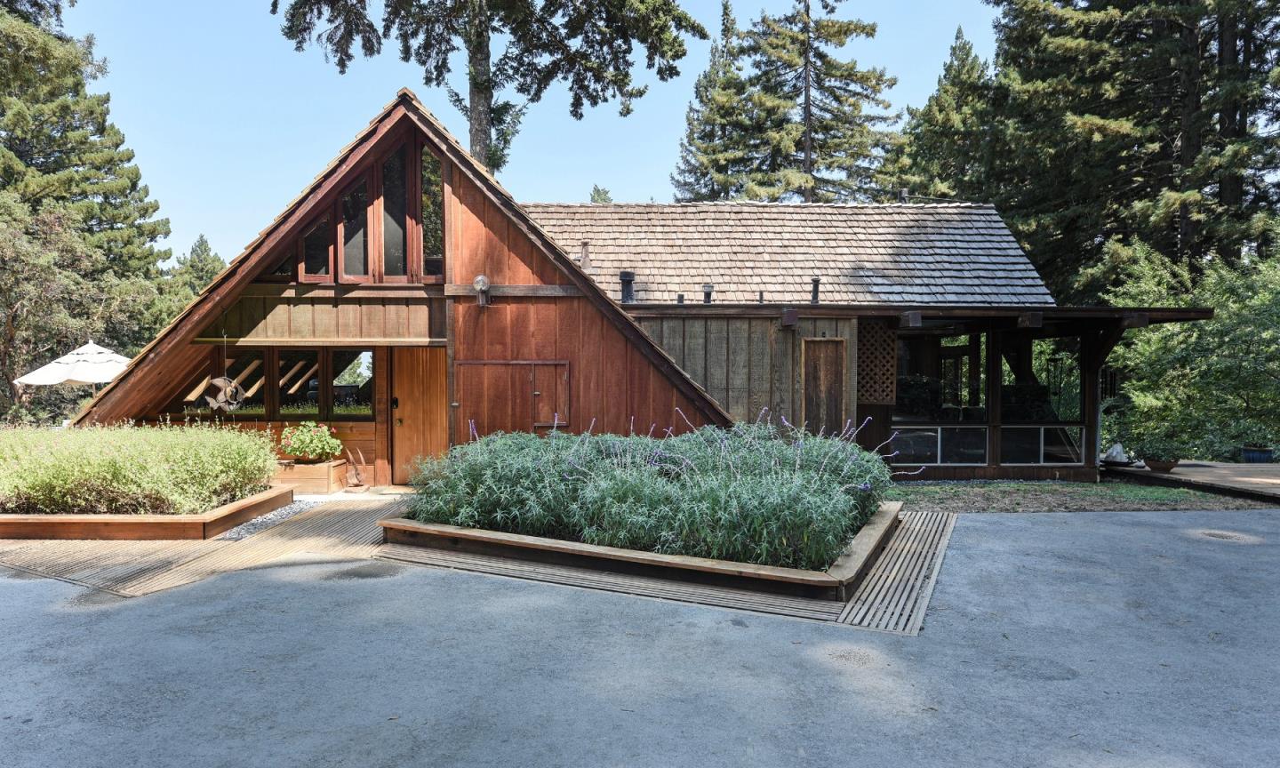 87 Upenuf Road Woodside, CA 94062 - Photo 4 of 42 a backyard of a house with wooden fence and trees