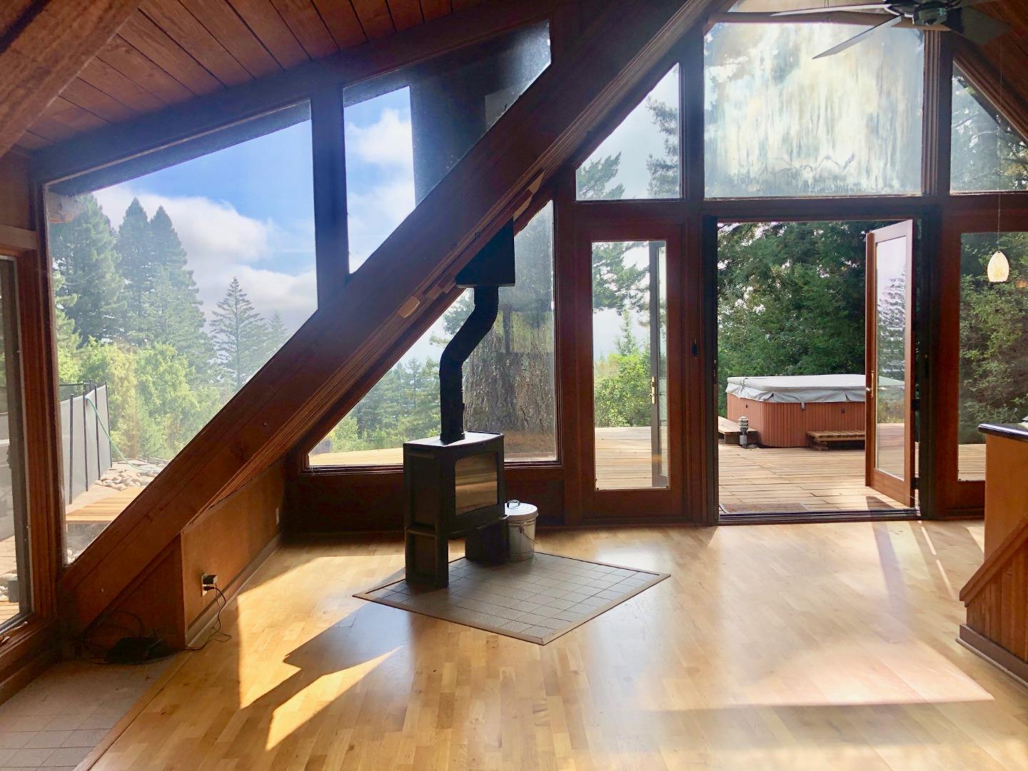 87 Upenuf Road Woodside, CA 94062 - Photo 10 of 42 a view of living room with large windows and wooden floor