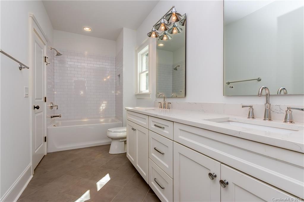 740 Ellsworth Road, Unit 45 Charlotte, NC 28211 - Photo 22 of 35 a spacious bathroom with a double vanity sink toilet mirror and bathtub
