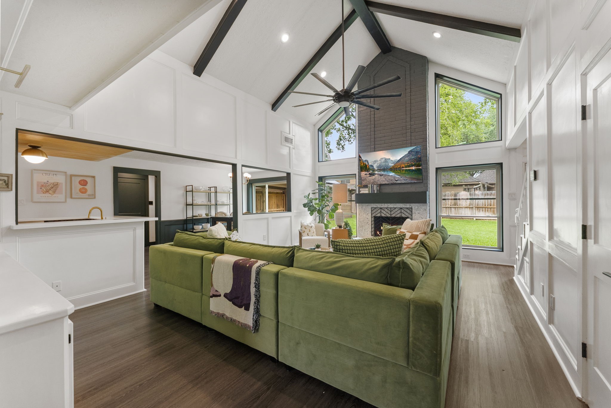 3414 Blue Candle Drive Spring, TX 77388 - Photo 4 of 29 Stunning open-concept living space featuring soaring vaulted ceilings with exposed beams, dramatic floor-to-ceiling windows, and abundant natural light.