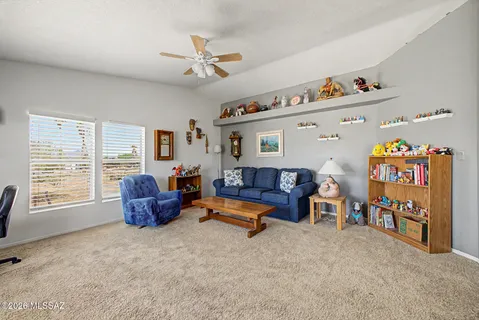 a living room with furniture toys and a window