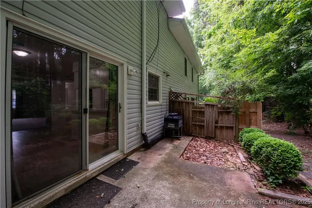 a view of backyard with glass door and outdoor space