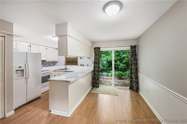 a kitchen with stainless steel appliances a stove a sink and a refrigerator