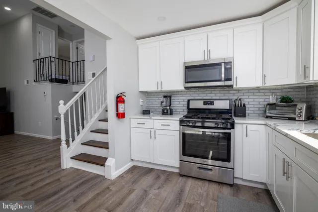 a kitchen with stainless steel appliances granite countertop a stove and a sink