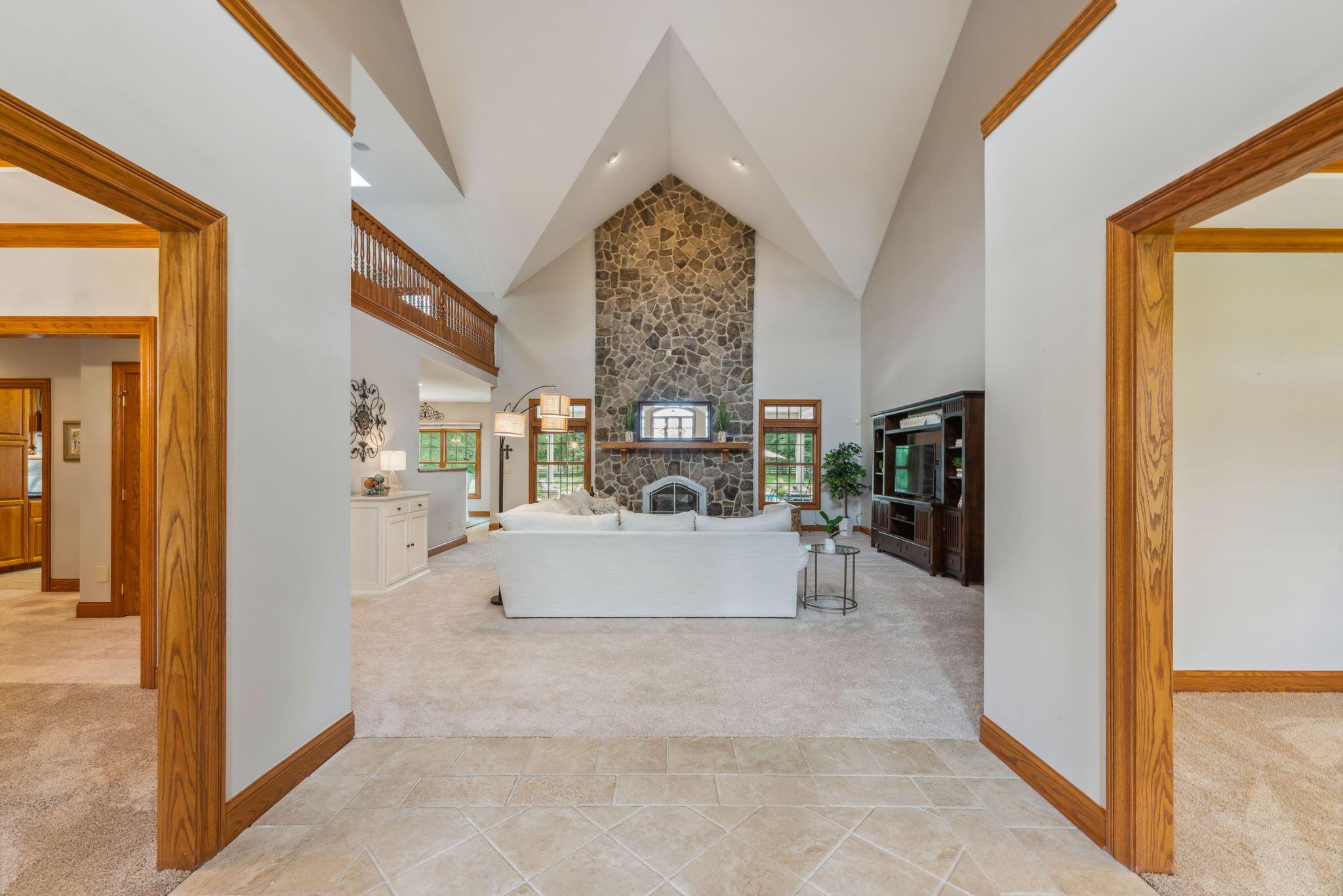 8242 Dustin Road Galena, OH 43021 - Photo 9 of 111 Grand entrance with cathedral vaulted ceilings giving the home the most dramatic entryway view into the Great Room. Dinning room to the left and den/office area to the right