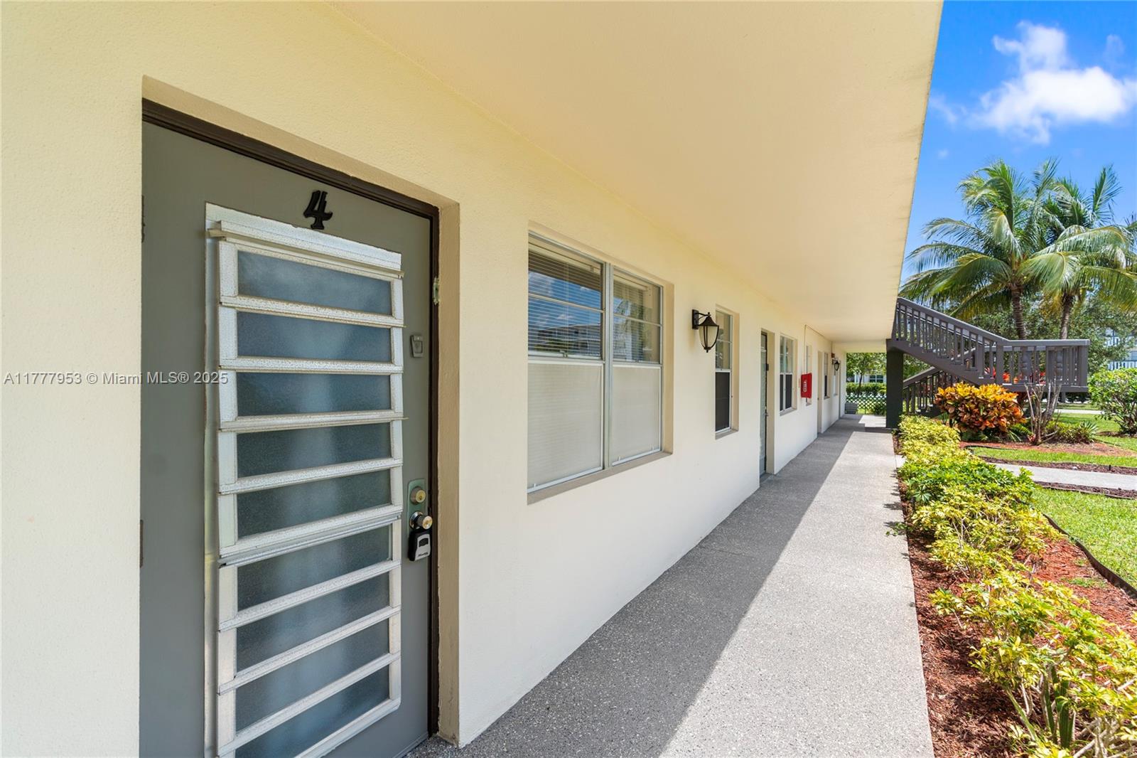 4 Markham A, Unit 4 Deerfield Beach, FL 33442 - Photo 18 of 23 a hallway with a large window and potted plants