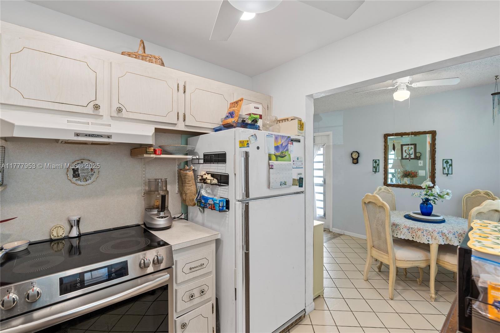 4 Markham A, Unit 4 Deerfield Beach, FL 33442 - Photo 8 of 23 a kitchen with a white cabinets and white appliances