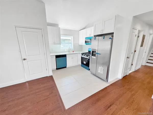 a kitchen with stainless steel appliances a refrigerator and a stove top oven