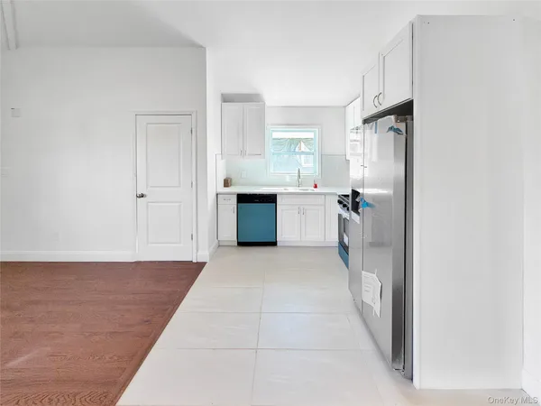 a large white kitchen with a sink