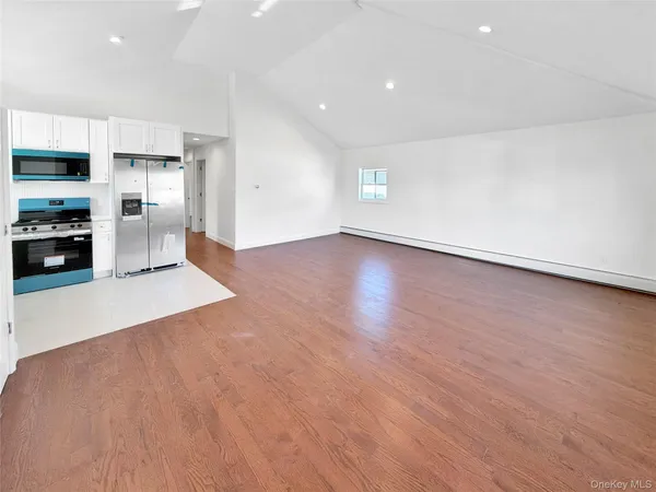 a view of a kitchen with a sink and a refrigerator