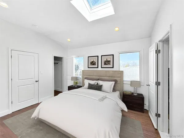 a bedroom with a large bed and a window