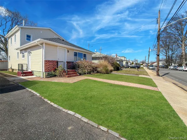a front view of house with yard and green space