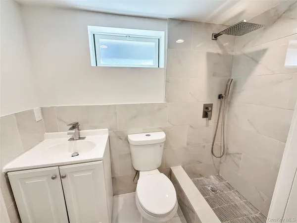 a bathroom with a toilet sink and shower
