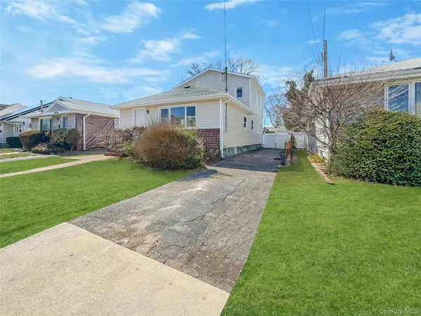 a front view of a house with a garden and yard
