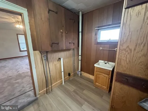 a bathroom with a sink a toilet a mirror and vanity