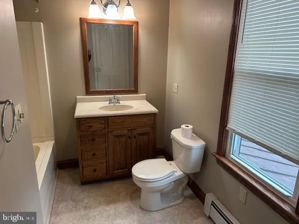 a bathroom with a toilet a sink and bathtub