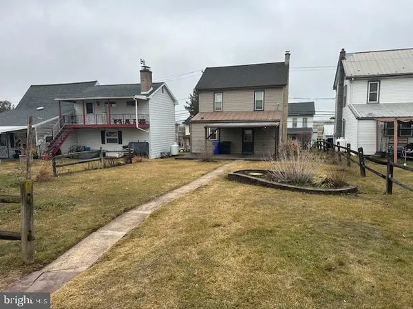 a view of a house with a yard and garage