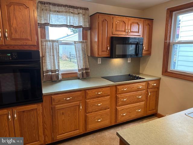 1033 Martindale Road Ephrata, PA 17522 - Photo 4 of 32 a kitchen with granite countertop wooden cabinets a stove a oven and a refrigerator with wooden floor