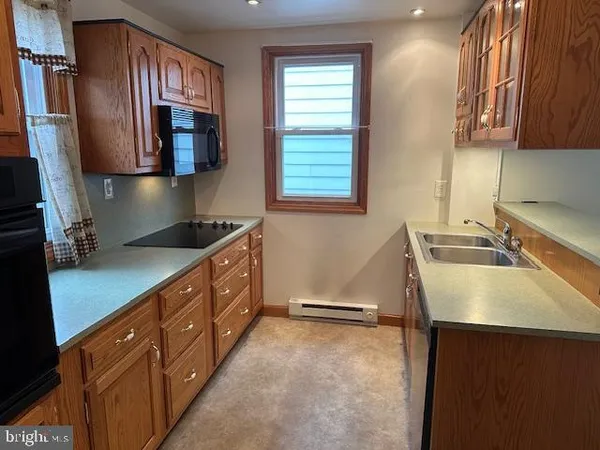 a kitchen with a sink stove and microwave