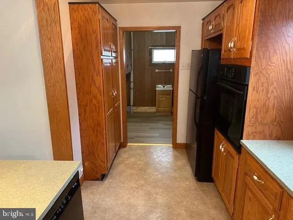 a kitchen with granite countertop cabinets and oven
