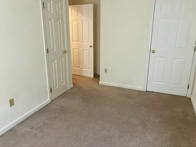 an empty room that has a grey walls