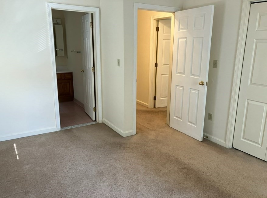 61 Kondazian Street, Unit 61 Watertown, MA 02472 - Photo 9 of 11 an empty room that has a grey walls