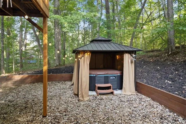 a backyard of a house with table and chairs