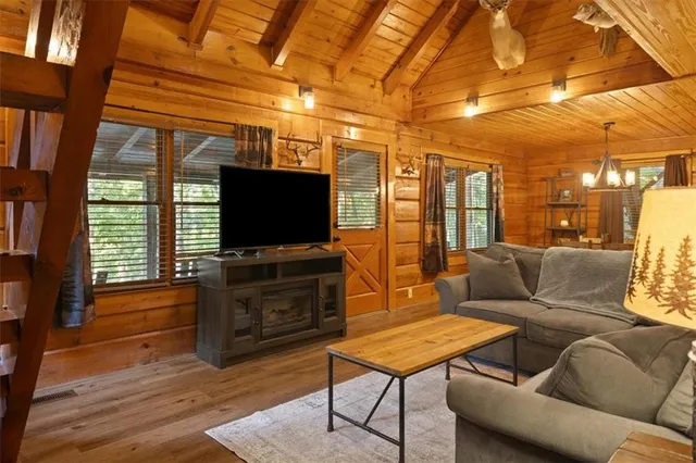 a living room with furniture and a flat screen tv