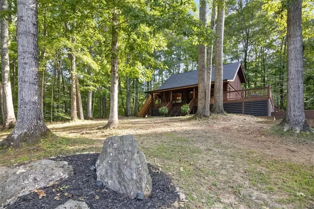 a view of a house with backyard and a tree