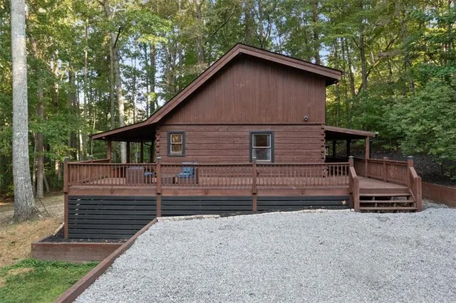 a view of a house with a yard and wooden fence