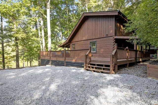 a backyard of a house with a small barn and a cactus tree
