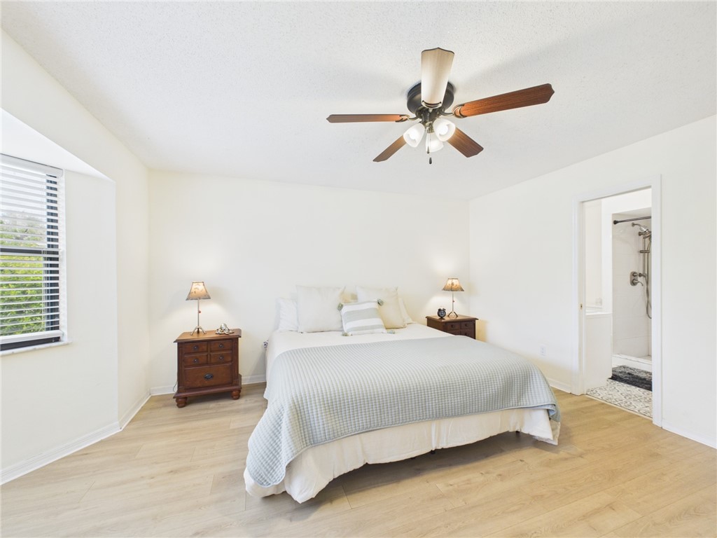 225 Midvale Terrace Sebastian, FL 32958 - Photo 15 of 25 a bedroom with a bed and a chandelier