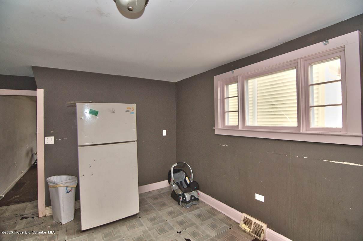 1716 Wayne Avenue Scranton, PA 18508 - Photo 11 of 42 a room with a window and a refrigerator