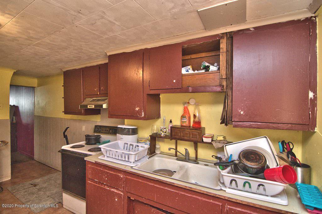 1716 Wayne Avenue Scranton, PA 18508 - Photo 22 of 42 a kitchen with a stove and a refrigerator